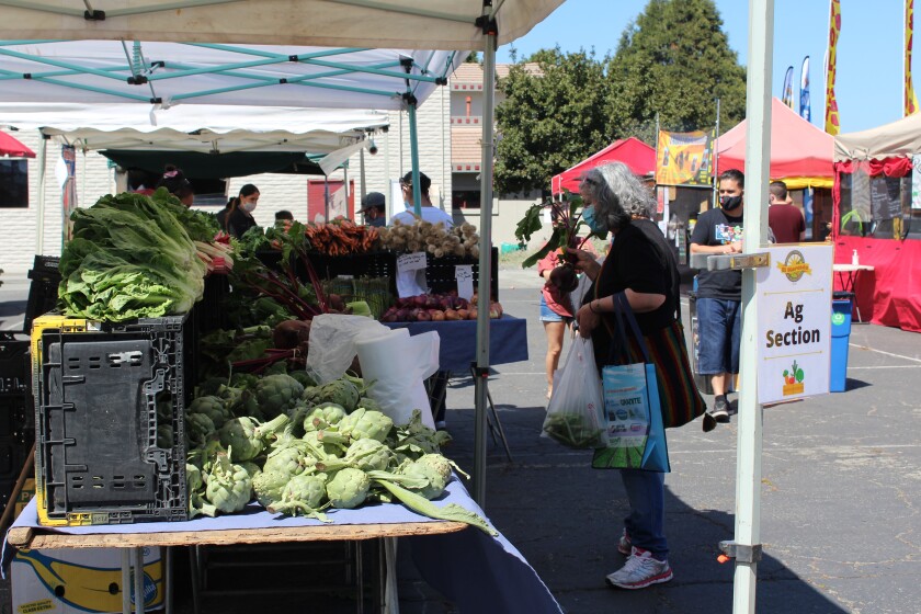 A vendor at the El Mercado farmers market at Watsonville's Ramsay Park